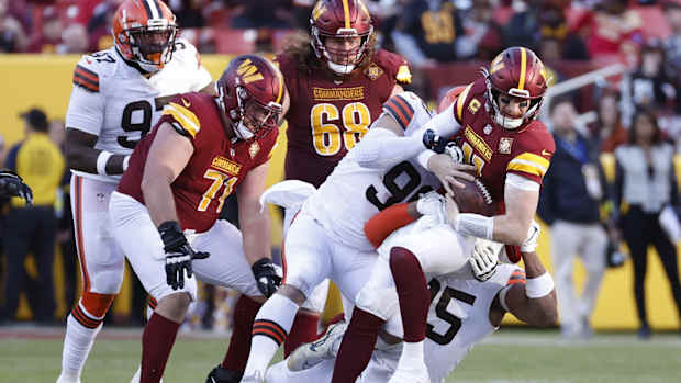 Jan 1, 2023; Landover, Maryland, USA; Cleveland Browns defensive end Myles Garrett (95) and Browns defensive tackle Jordan Elliott (96) sack Washington Commanders quarterback Carson Wentz (11) during the third quarter at FedExField. Mandatory Credit: Geoff Burke-USA TODAY Sports
